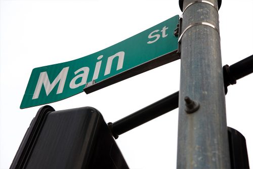a photograph of a street sign that reads "Main Street"