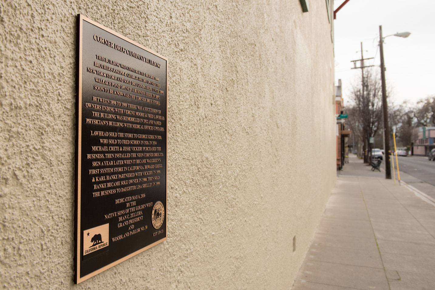 A photograph of the plaque outside of Corner Drug in Woodland CA